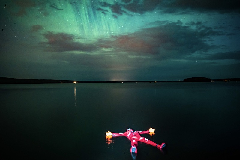 Floating in a lake in Rovaniemi under Auroras