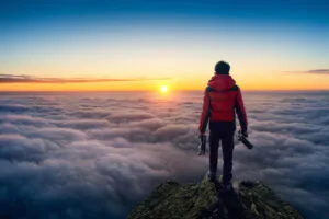 A traveler on top of a mountain in Poland watching sunrise