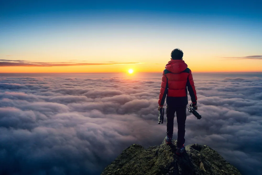 A traveler on top of a mountain in Poland watching sunrise