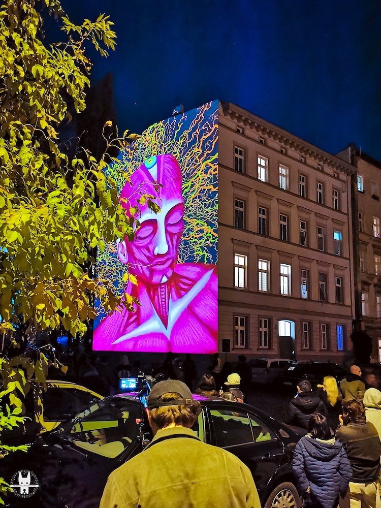 People watching Wrocław moving murals in Nadodrze