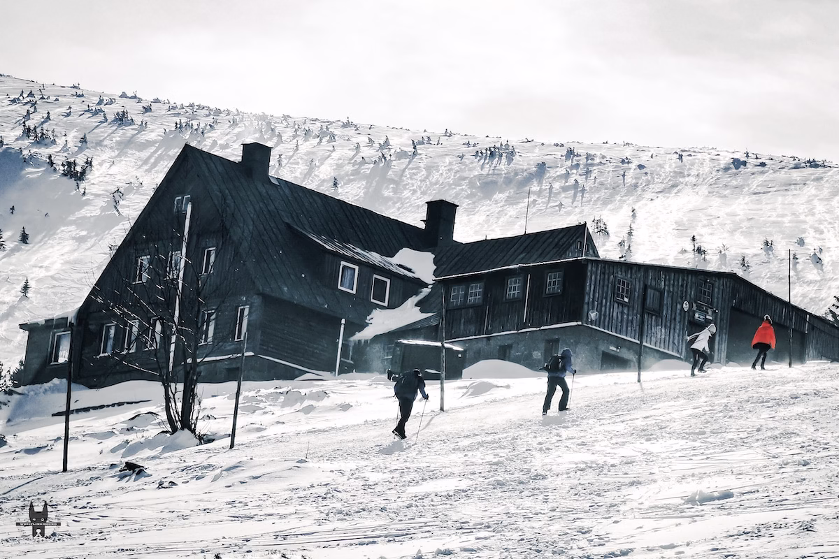 Hikers crossing PTTK Schronisko Pod Łabskim Szczytem in Lower Silesia